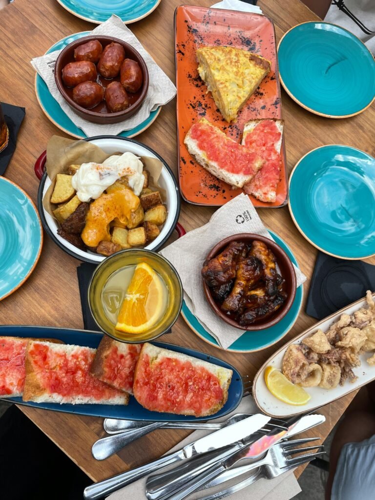 pexels-photo-9271980-9271980 A vibrant display of traditional Spanish tapas served on colorful plates, showcasing diverse flavors.
